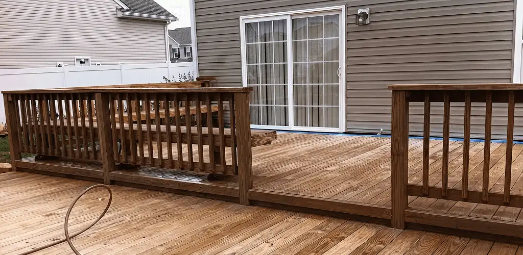 Deck sealing service protecting a backyard wood deck and railings in Boca Raton, FL