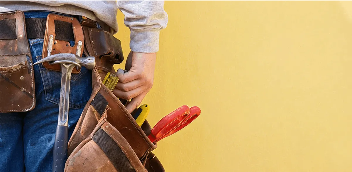 Handyman with tool belt ready for home repairs and maintenance in Boca Raton, FL
