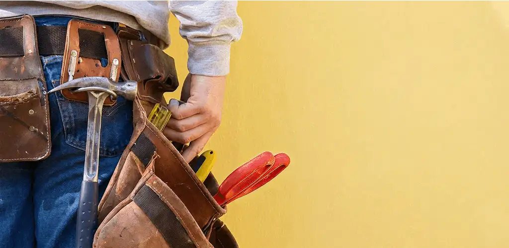 Handyman with tool belt ready for home repairs and maintenance in Boca Raton, FL