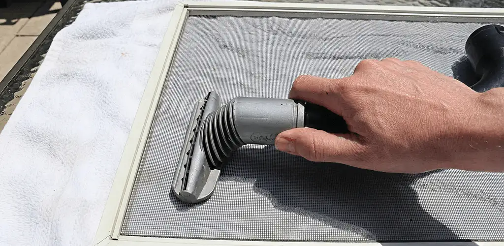 Window screen repair cleaning and fixing a damaged screen mesh in Boca Raton, FL